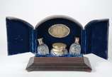 Conjunto com par de perfumeiros e poseira de cr... - Conjunto com par de perfumeiros e poseira de cristal europeu lapidado e tampas de prata, acondicionados em estojo forrado na parte interna e peq...