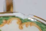 Limoges (1771),  - Conjunto com 12 xícaras com pires para café de porcelana francesa, decoradas com flores em policromia e guirlandas na cor verde e frisos dourados (uma