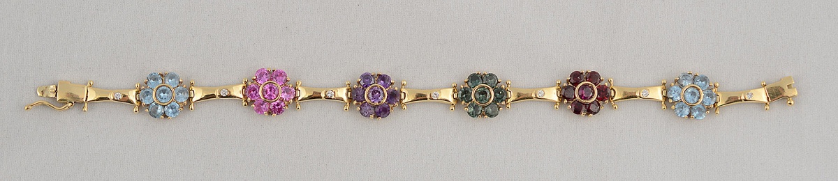 Pulseira de ouro amarelo 18 k com 7 brilhantes e diversas pedras...
