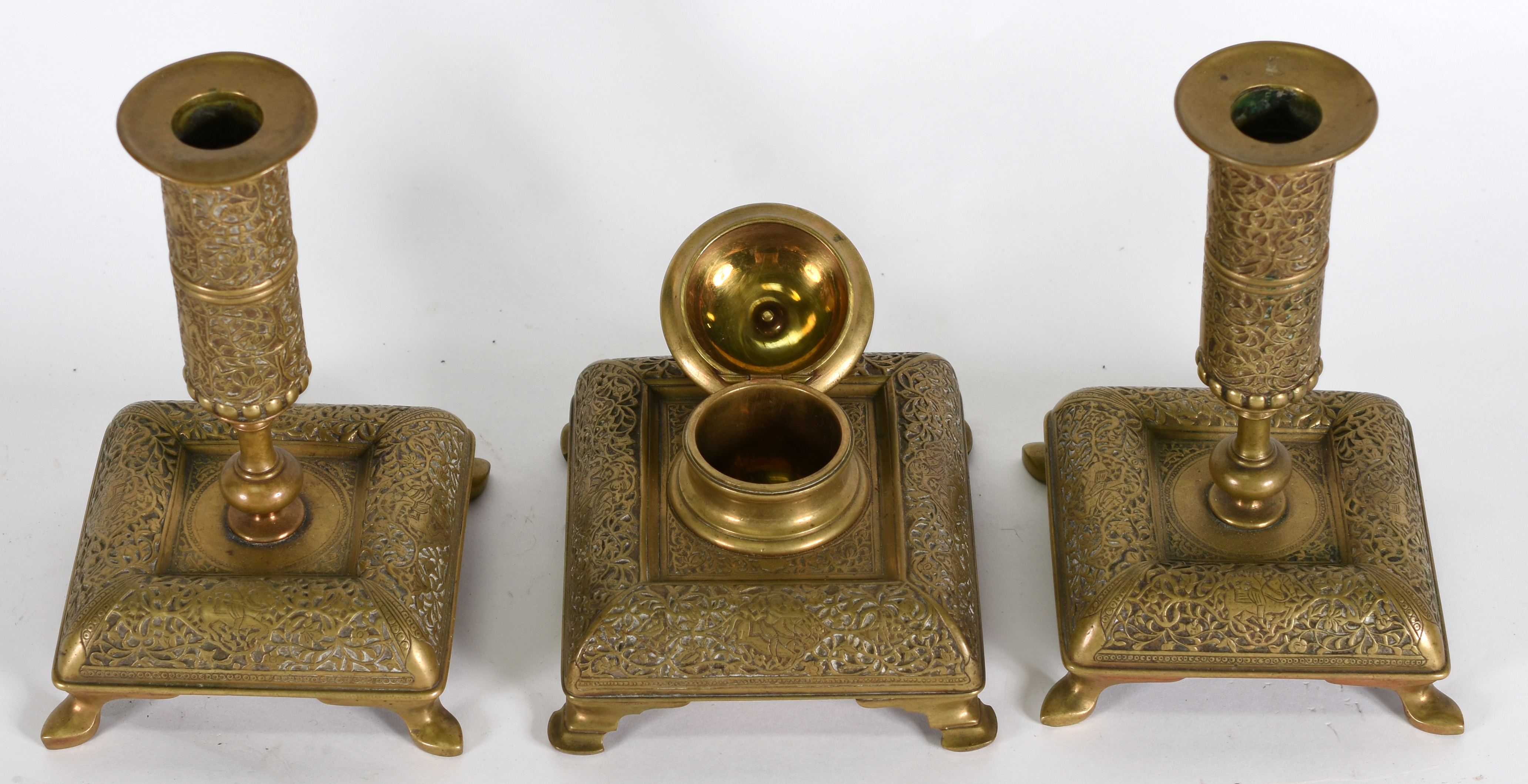 Três peças , sendo, tinteiro e par de castiçais de metal dourado . - foto 3 de 3