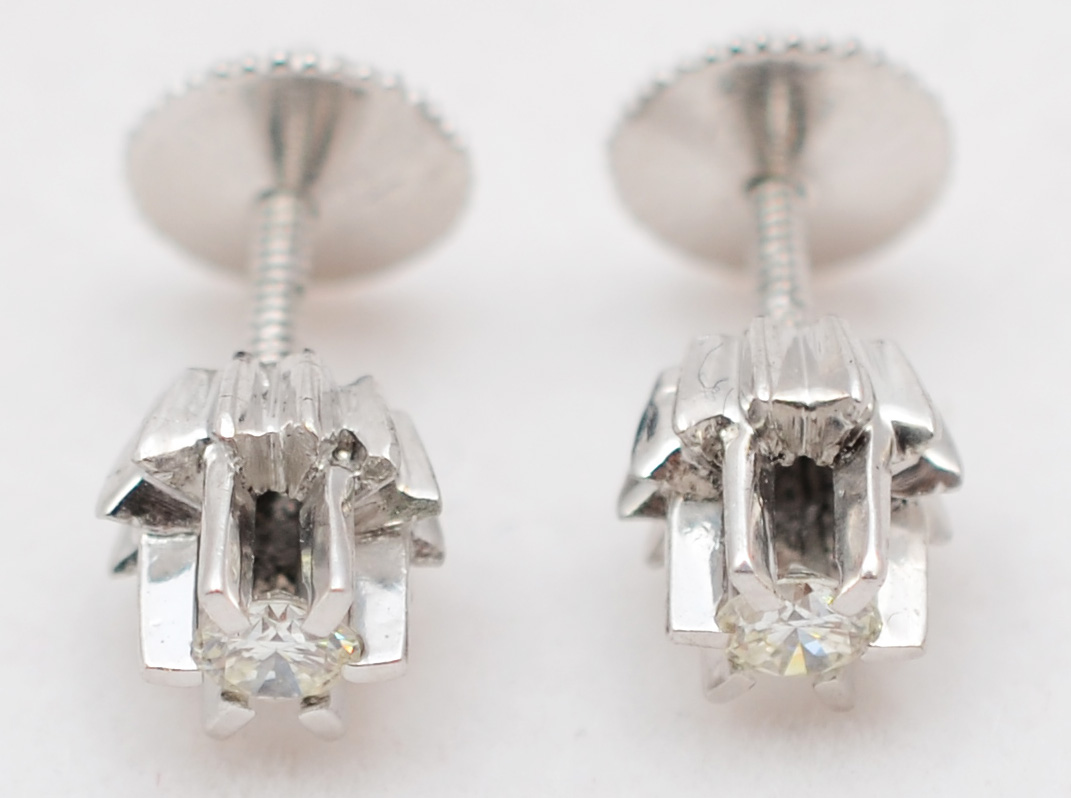 Par de brincos solitário de ouro branco com aproximadamente 0.40 ct...