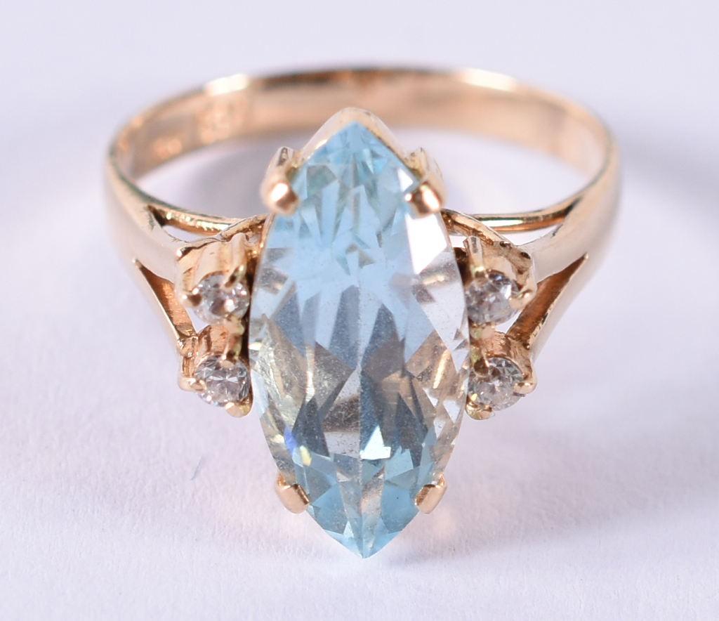 Anel de ouro 14 k com 4 brilhantes e topázio azul .Aro 15. (por... - foto 1 de 4