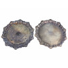 <p>Par de bandejas de servir em metal prateado (silver plate), manufatura Toledo, Indústria Argentina, com decoração floral, bordas recortadas com motivos de conchas e apoiadas sobre três pés - 40 cm diâm</p>