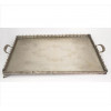 <p>Grande tabuleiro de metal espessurado à prata, galeria fenestrada com ramagens, bandeja com guirlandas, contém duas alças laterais estilizadas. Comp. 79 x 50 x 06cm. Brasil, séc. XX(falta um dos pés)</p>