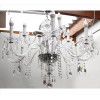 <p>Lustre de cristal lapidado estiloMaria Thereza, 12 braços, decorado com pingentes diversos. Alt. 75 x 100cm (aproximadamente). Séc. XX</p>