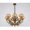 <p>Lustre de bronze dourado contendo 08 braços, ornamentado com ramagens e caneluras, contém Alt. 50 x 76cm. Início séc. XX</p>