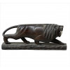 <p>Escultura de madeira nobre, possivelmente pau-ferro ou gonçalo-alves, representando figura de leão, presas de osso, olhos de vidro. Alt. 13 x 34 x 08cm. Brasil, séc. XX (falta um olho)</p>
