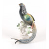 <p>PROF. KARL ENS,VOLKSTEDT - Escultura em porcelana esmaltada Alemã representando pássaro. Alemanha Sec XIX/XX. Karl Ens foi um fabricante alemão de porcelanas ligado à tradicional manufatura de Volkstedt, na Turíngia. No início do século XX, sua fábrica ganhou fama internacional pela produção de figuras de animais, flores e peças decorativas em estilo refinado. Entre 1919 e 1939, sob sua direção, alcançou o auge da qualidade e exportação. As peças trazem marcas como o moinho de vento verde ou o nome ENS. Após 1945, a fábrica foi nacionalizada na Alemanha Oriental. Hoje, suas porcelanas são muito valorizadas por colecionadores. 30 cm alt, (No estado).</p>