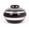<p>RUPPEL/ BOOM - Imponente vaso do período Art Déco, executado em vidro opalino preto decorado com faixas prateadas aplicadas horizontalmente. A peça, de grande presença e refinamento formal, é atribuída ao fabricante belga Ruppel/Boom, conhecido pela excelência técnica e pelas composições geométricas características do estilo. Assinatura do designer na base. Dimensões: Altura 24 cm × Largura 33 cm</p>