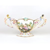 <p>CAPODIMONTE - Centro de mesa em faian&ccedil;a, com rica policromia em esmalte, al&ccedil;as laterais trabalhadas representando anjos e rico trabalho na parte central em alto-relevo, representando figura com querubins. 23 cm de alt.; 40 x 14 cm. IT&Aacute;LIA, s&eacute;c. XX.</p>