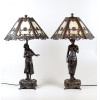 <p>Par de abajures estilo Art Nouveau, com base escult&oacute;rica em petit bronze patinado, representando figuras femininas, c&uacute;pula em bronze vazada com rica decora&ccedil;&atilde;o floral e parte interna em vidro leitoso. 72 cm de alt.; 44 cm de di&acirc;m.</p>