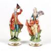 <p>Capodimonte, par de esculturas em biscuit policromado, representando casal de nobres. 21 cm de alt. Itália, início do séc. XX. (Peça com bicado)</p> <p>Capodimonte, par de esculturas em biscuit policromado, representando casal de nobres. 21 cm de alt. Itália, início do séc. XX. (Peça com bicado)</p>
