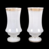 <p>Par de belíssimos vasos em cristal opalinado, decorados com filetes dourados nas bordas. França, séc. XIX. 24 cm de alt.; 12 cm de diâm. (com bicado).</p>