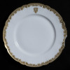 <p>Prato de porcelana - França, séc. XIX/XX. Prato de porcelana, aba com borda ondulada, delimitada por friso dourados decorado com ramos repetitivos em relevo, contendo o monograma entrelaçado pertencente a Evaristo da Veiga, no reverso marca Haviland e etiqueta de coleção; 21,5 cm de diâmetro. Apresenta perdas na borda.</p>