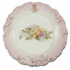 <p>Prato de porcelana; aba rosa com relevos; borda recortada com realces dourados; apresentando monograma MNL - Ayapuá; no reverso marca de Vista Alegre; 23 cm de diâmetro. Portugal, séc. XIX.</p>